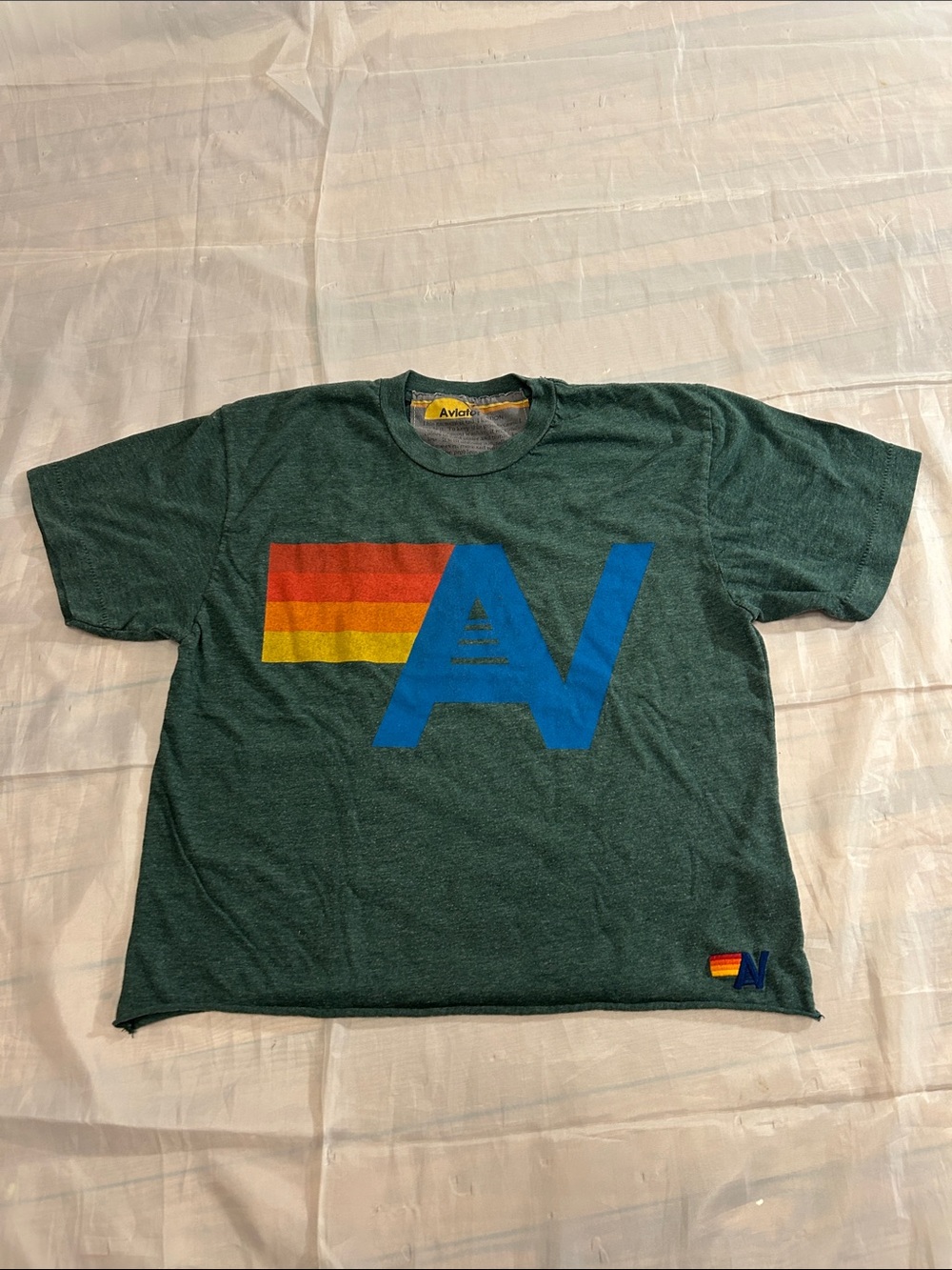 Aviator Nation Dark Green Tee with Blue 'A' Logo and Red-Orange-Yellow Stripes